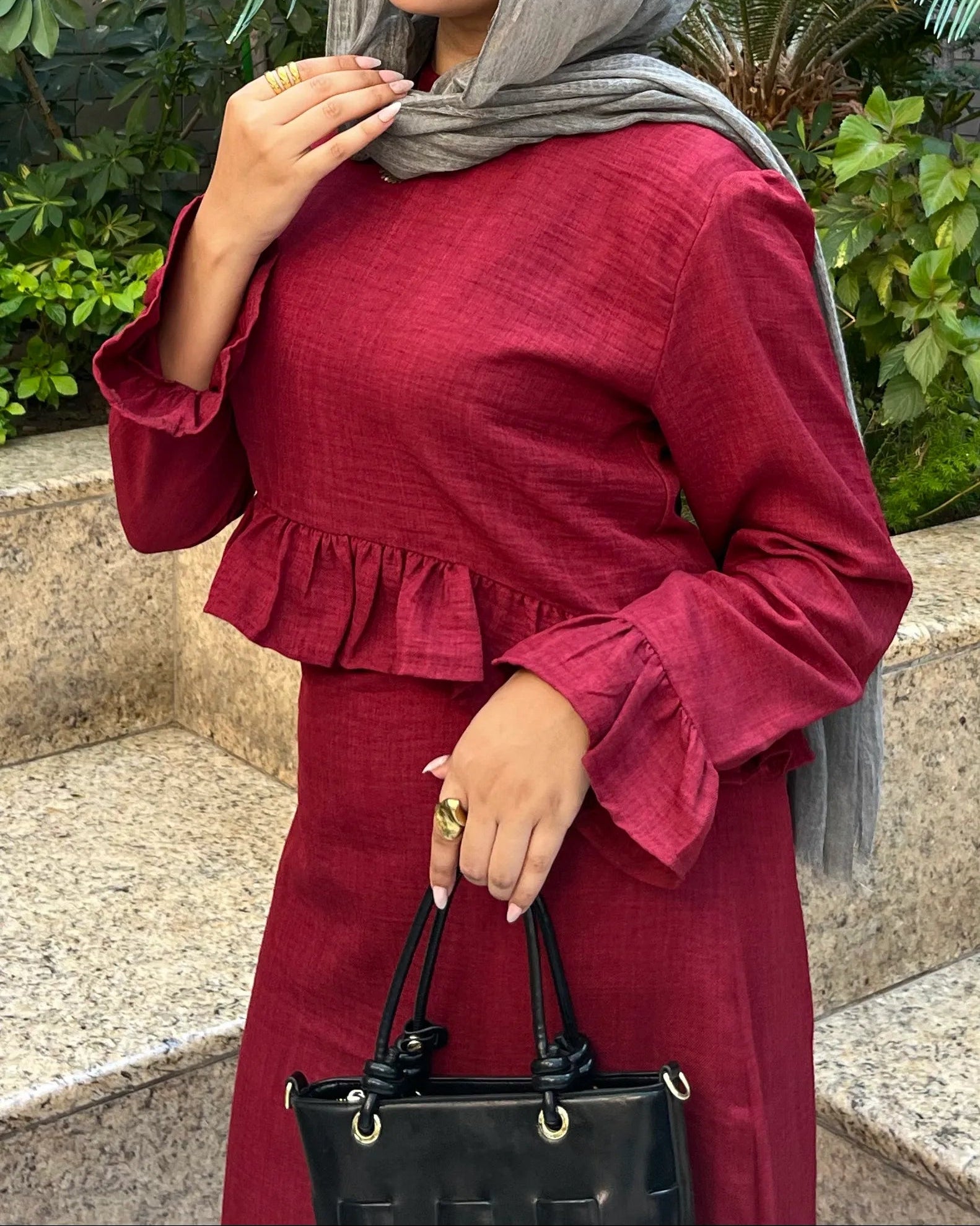 Elara Dress burgundy ruffle top close-up with black handbag