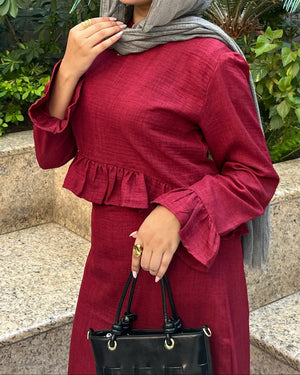 Elara Dress burgundy ruffle top close-up with black handbag