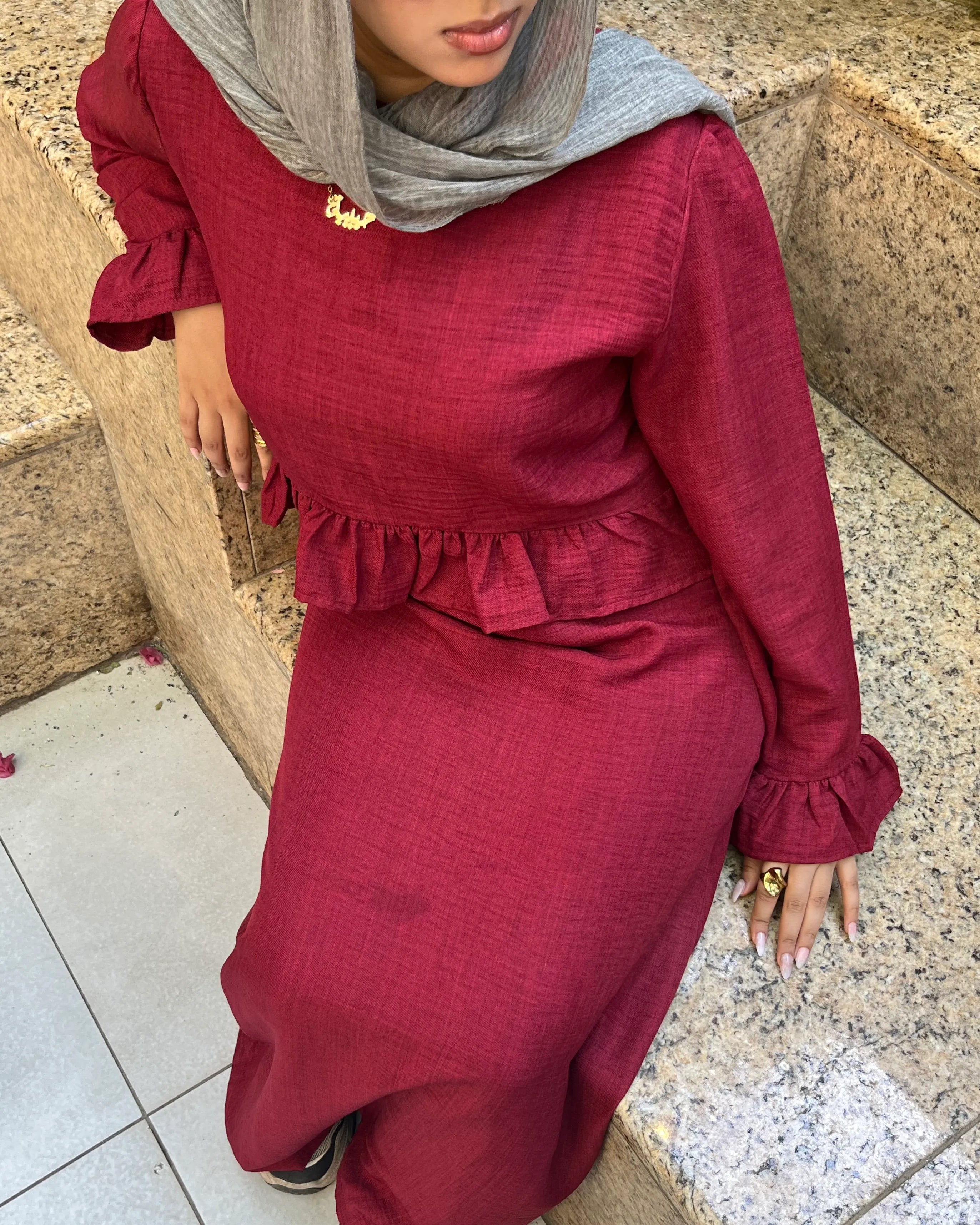 Elara Dress burgundy two-piece set seated view showing ruffle detail