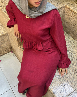 Elara Dress burgundy two-piece set seated view showing ruffle detail
