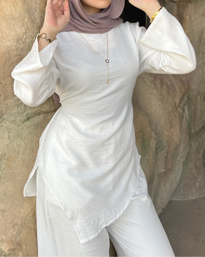Élan Top in White – women's linen asymmetric top, side view styled with jeans