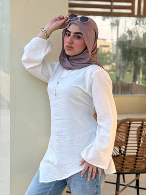Élan Top in White – women's premium linen asymmetric top, front view styled with jeans